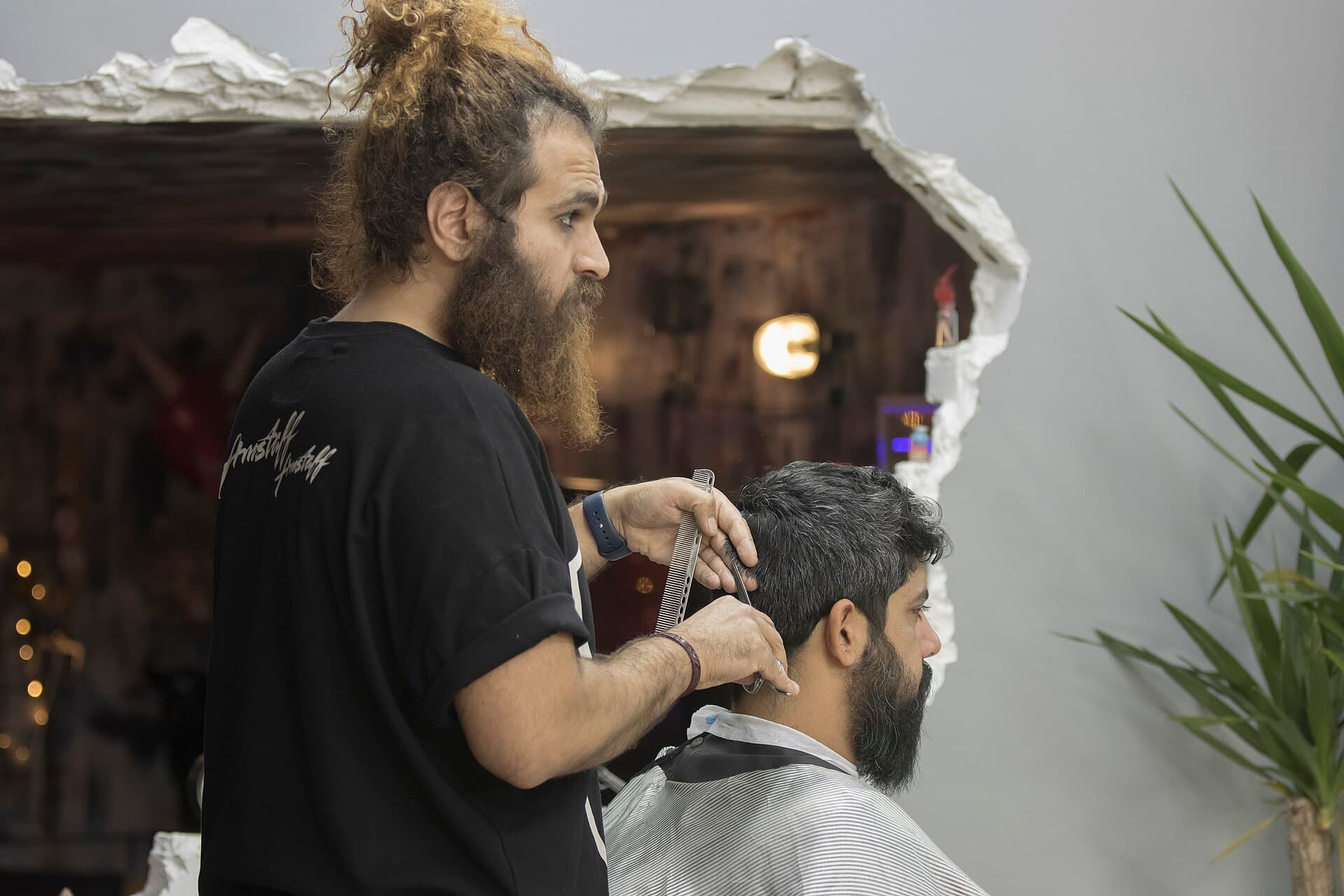 A softly lit beauty salon interior with mirrors, chairs, and styling stations.